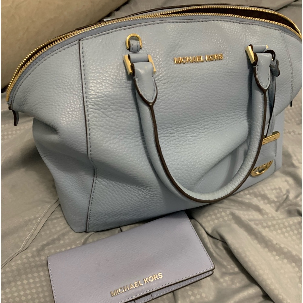 Pastel blue Michael Kors handbag and matching wallet.